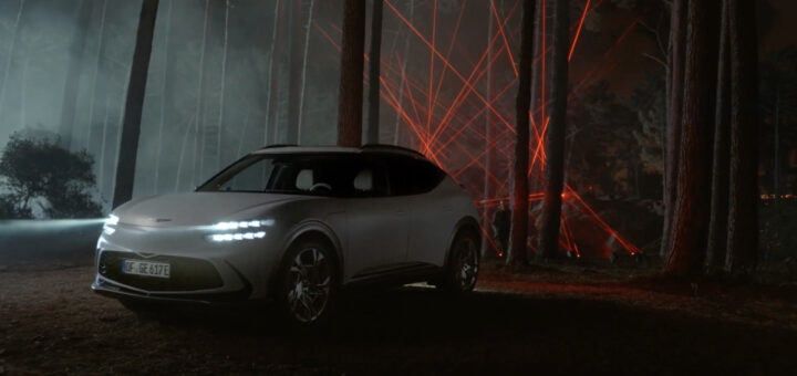 The new all electric Genesis GV60 on a light installation on the woods